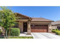 Charming single-story home with well-maintained landscaping and a two-car garage at 7440 E Osage Ave, Mesa, AZ 85212