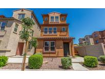 Charming three-story home featuring desert landscaping and a cozy front porch at 7732 W Bonitos Dr, Phoenix, AZ 85035