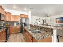 Open kitchen featuring granite countertops, stainless appliances, and a breakfast bar at 8209 S 23Rd Pl, Phoenix, AZ 85042