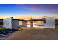 Charming single-story home with a red tile awning and white painted brick facade at 8326 E Crestwood Way, Scottsdale, AZ 85250