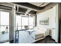 Bright living room with floor-to-ceiling windows and sleek, modern decor at 1 E Lexington Ave # 1306, Phoenix, AZ 85012