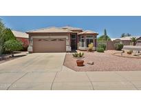 Charming single-story home features a desert landscaped front yard with a two car garage at 11038 W Oraibi Dr, Peoria, AZ 85373