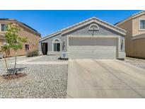Single story home features a two car garage, low maintenance yard, and neutral color scheme at 12318 W Bloomfield Rd, El Mirage, AZ 85335