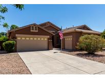 Charming single-story home features a spacious three-car garage and a well-maintained front yard at 1247 E Bautista Rd, Gilbert, AZ 85297