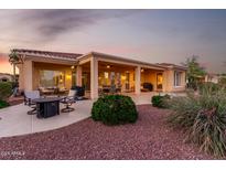 Inviting outdoor space with a covered patio, comfortable seating, and professionally designed desert landscaping at 13219 W Santa Ynez Dr, Sun City West, AZ 85375