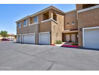 Exterior view of townhome with multiple garages, highlighting the convenient parking at 1335 E June St # 221, Mesa, AZ 85203