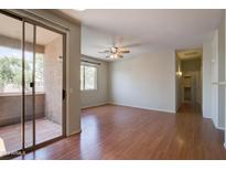 Spacious, unfurnished living room with sliding glass door access to covered balcony at 1335 E June St # 221, Mesa, AZ 85203