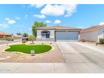 Charming single story home with desert landscaping and a well manicured artificial lawn at 1384 E Leslie Ave, San Tan Valley, AZ 85140