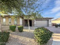 Charming single-story home featuring desert landscaping, stone accents, and a two-car garage at 14572 W Medlock Dr, Litchfield Park, AZ 85340