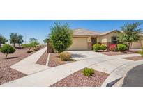Charming single-story home with a well-manicured yard, desert landscaping, and inviting curb appeal at 17345 W Spur Dr, Surprise, AZ 85387