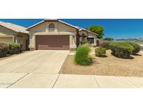 Charming single-story home with a well-maintained front yard, desert landscaping and brown garage door at 1950 E Kings Ave, Phoenix, AZ 85022