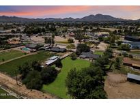 Expansive aerial view of the property featuring mature trees, horse facilities, and a serene desert landscape at 23265 S Via Del Arroyo --, Queen Creek, AZ 85142