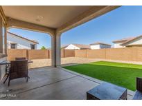 Covered patio with view of gravel, turf, and block fence at 25601 N 140Th Ln, Surprise, AZ 85387