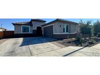Charming single-story home featuring desert landscaping, a two-car garage, and a neutral color palette at 25968 W Tina Ln, Buckeye, AZ 85396