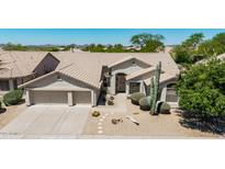 Charming home features a well-manicured desert front yard with a large, attached two-car garage at 29816 N 51St Pl, Cave Creek, AZ 85331