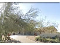 Charming single-story home featuring a well-maintained yard and inviting curb appeal with a paved driveway at 34611 N Sunset Trl, Cave Creek, AZ 85331