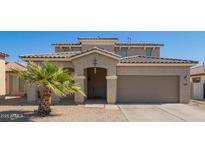 Inviting home exterior featuring desert landscaping and a two-car garage at 36179 W Cartegna Ln, Maricopa, AZ 85138