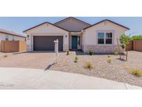 Charming single-story home with a two-car garage, desert landscaping, and a welcoming front porch at 40595 W Michaels Dr, Maricopa, AZ 85138