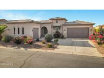 Charming, Southwestern-style home with a well-manicured lawn and a three-car garage at 41584 W Springtime Rd, Maricopa, AZ 85138