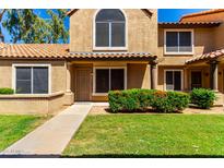 Inviting two-story home featuring a well-maintained lawn and desert-friendly landscaping, exuding charm at 4601 N 102Nd Ave # 1116, Phoenix, AZ 85037