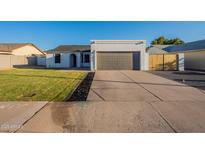 Charming home features a well-manicured lawn, neutral color palette, and a two-car garage at 4855 E Gary St, Mesa, AZ 85205