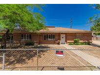 Charming brick home featuring mature trees, a well-manicured lawn, and a 'no trespassing' sign at 6100 N 36Th Ave, Phoenix, AZ 85019