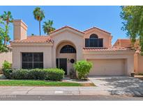 Charming two-story home featuring a landscaped yard and a two-car garage at 67 W Sarah Ln, Tempe, AZ 85284
