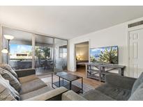 Inviting living room with a comfortable sofa, stylish coffee table, and a private balcony with great outdoor views at 7625 E Camelback Rd # B226, Scottsdale, AZ 85251