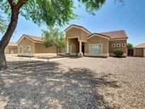 Inviting single-story home featuring desert landscaping, a tile roof, and a welcoming front entrance at 8031 W Morten Ave, Glendale, AZ 85303