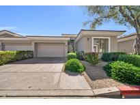 Charming single-story home featuring a two-car garage, desert landscaping, and a neutral color palette at 8180 E Shea Blvd # 1019, Scottsdale, AZ 85260