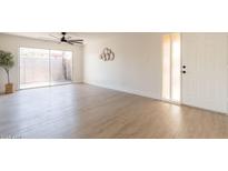 Spacious living room featuring new floors, ceiling fan, large sliding door, and ample natural light at 909 S Acapulco Ln # A, Tempe, AZ 85281