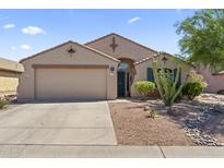 Charming single-story home featuring a two-car garage and desert landscaping for low maintenance living at 10333 E Gold Nugget Ct, Gold Canyon, AZ 85118