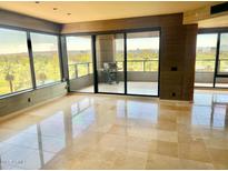 Spacious living room featuring large windows and a balcony with a grill, offering city views at 1040 E Osborn Rd # 501, Phoenix, AZ 85014