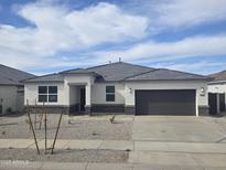 Charming single-story home with a well-maintained yard and a two-car garage at 15389 W Cottontail Ln, Surprise, AZ 85387