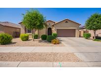 Charming single-story home boasts a well-manicured front yard and inviting curb appeal at 15862 W Fillmore St, Goodyear, AZ 85338
