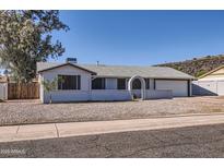 Charming single-story home featuring a well-maintained yard and attached two-car garage at 1718 W Voltaire Ave, Phoenix, AZ 85029