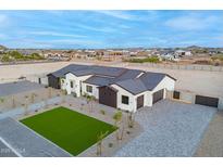 An aerial view captures the home's gray roof, modern exterior, driveway, landscaping, and neighborhood at 2005 W Lincoln Ct, Queen Creek, AZ 85144