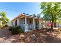 Charming single-story home with a welcoming front porch and well-maintained landscaping at 201 S Greenfield Rd # 29, Mesa, AZ 85206