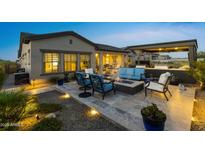 Inviting outdoor patio featuring a cozy fire pit and comfortable seating arrangement for relaxing evenings at 20795 W San Juan Ave, Buckeye, AZ 85396