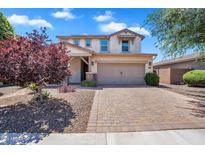 Charming two-story home featuring a spacious driveway, manicured landscaping, and a two-car garage at 242 N Crosscreek Dr, Chandler, AZ 85225