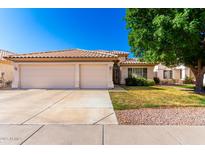 Charming single-story home with a three-car garage, tiled roof, and a well-maintained front yard at 3412 E Kristal Way, Phoenix, AZ 85050