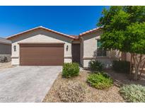 Charming single-story home with a two-car garage, desert landscaping, and a warm, inviting facade at 3415 S 75Th Dr, Phoenix, AZ 85043