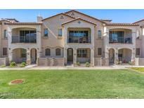 Charming townhome with stucco facade, second story balcony, and well-manicured lawn at 4157 E Pinto Dr, Gilbert, AZ 85296