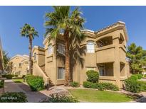 Inviting condo exterior with lush landscaping and palm trees at 5335 E Shea Blvd # 2081, Scottsdale, AZ 85254