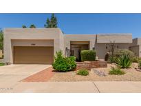 Attractive single-story home with a desert landscape and an attached two-car garage at 9389 N 87Th Way, Scottsdale, AZ 85258