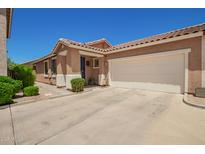 Charming single-story home featuring a tile roof, a two-car garage and an inviting blue front door at 963 S Colonial Dr, Gilbert, AZ 85296