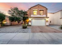 Inviting two-story home featuring a well-maintained front yard and brick-paved driveway at 12026 W Salter Dr, Sun City, AZ 85373