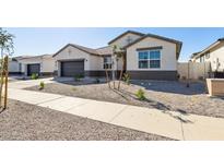Beautiful one-story home with neutral tones, low maintenance landscaping, and a two-car garage at 15402 W Cottontail Ln, Surprise, AZ 85387