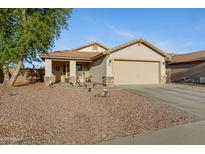 Charming single-story home featuring low maintenance desert landscaping and a neutral color palette at 1673 S 171St Dr, Goodyear, AZ 85338