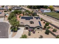 Stunning aerial view of a solar-paneled home with a lush backyard oasis, pool, and mature landscaping at 2101 S 167Th Dr, Goodyear, AZ 85338